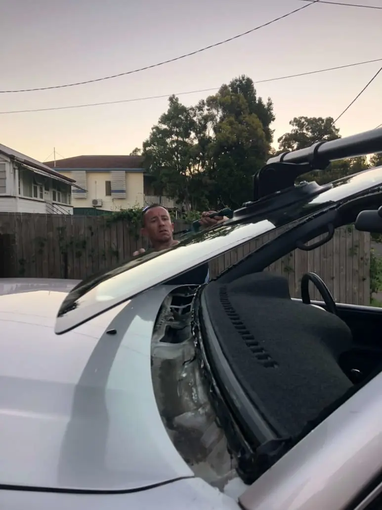 Windscreen removal tools in use on a vehicle