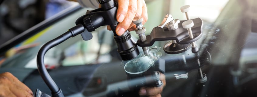 Repairs Scaled - The broken car glass being repaired using professional equipment.